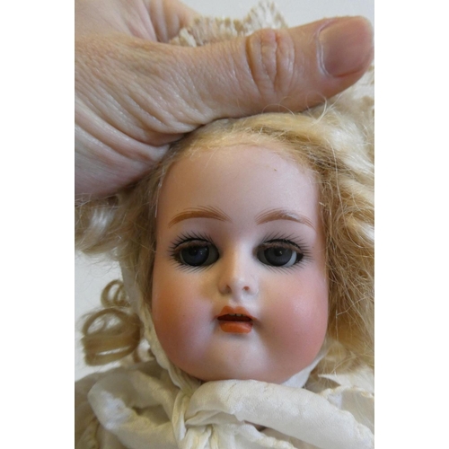 47 - A Kammer & Reinhardt bisque socket head doll with blue glass sleeping eyes, open mouth, teeth, pierc... 