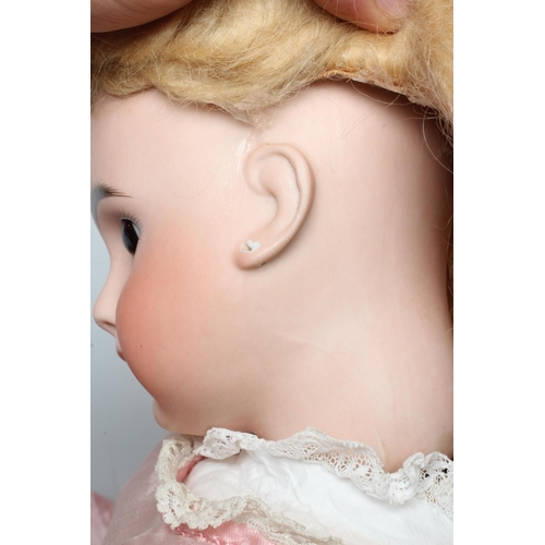 54 - A Belton type doll, with brown glass fixed eyes, closed mouth, pierced ears, blond wig, wood and com... 