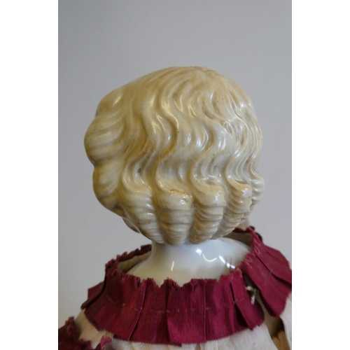 57 - A Victorian china shoulder head doll with painted features, moulded hair, jointed kid body, lace dre... 