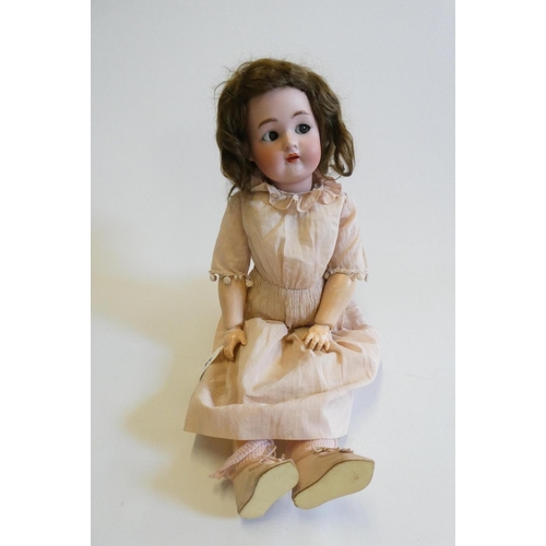 59 - A Simon & Halbig Kammer & Reinhardt bisque socket head doll with brown glass sideways glancing flirt... 