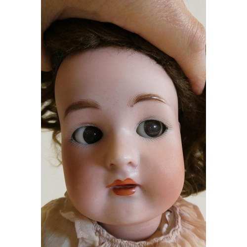 59 - A Simon & Halbig Kammer & Reinhardt bisque socket head doll with brown glass sideways glancing flirt... 