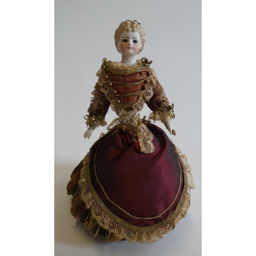 63 - A rare late Victorian bisque shoulder head fortune doll with blue glass fixed eyes, moulded blond ha... 