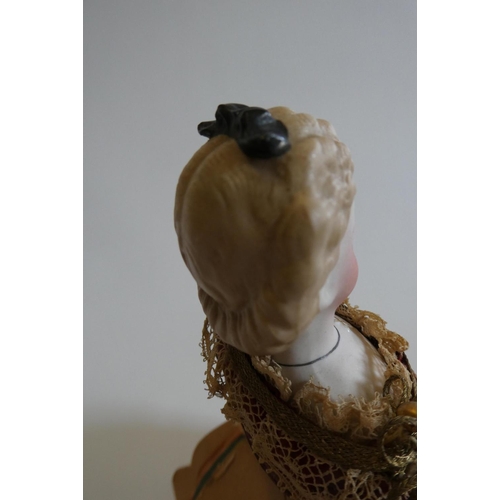 63 - A rare late Victorian bisque shoulder head fortune doll with blue glass fixed eyes, moulded blond ha... 