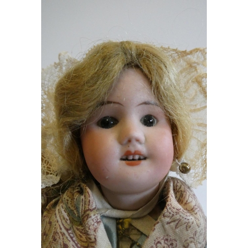 65 - An SFBJ bisque socket head doll, with brown glass fixed eyes, open mouth, teeth, blond wig, composit... 