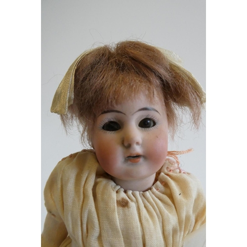 70 - A Simon & Halbig bisque socket head doll, with brown glass sleeping eyes, open mouth, short brown wi... 