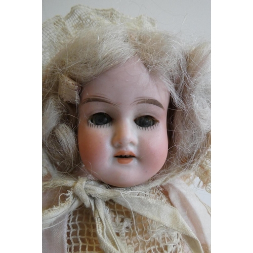 72 - An Armand Marseille bisque socket head doll, with blue glass sleeping eyes, open mouth, teeth, wood ... 