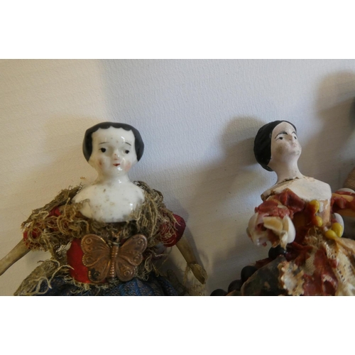 73 - Three Victorian doll's house dolls, comprising two china head dolls with painted features, moulded h... 