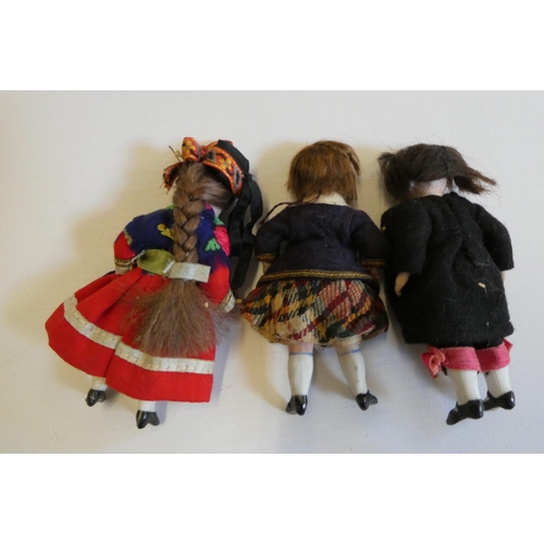 76 - Three all bisque doll's house dolls, with five piece bodies, two with brown glass fixed eyes, the ot... 