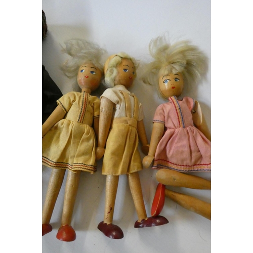 86 - Five wooden peg dolls, comprising one 11 3/4