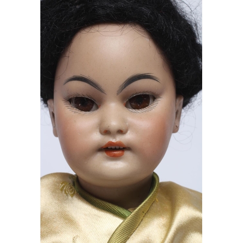 87 - A Simon & Halbig bisque socket head Asian girl doll, with brown glass sleeping eyes, open mouth, tee... 