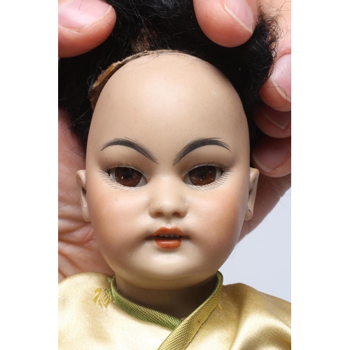 87 - A Simon & Halbig bisque socket head Asian girl doll, with brown glass sleeping eyes, open mouth, tee... 