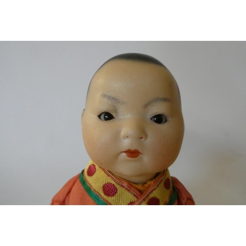 96 - An Armand Marseille bisque socket head Asian doll, with brown glass sleeping eyes, closed mouth, pai... 