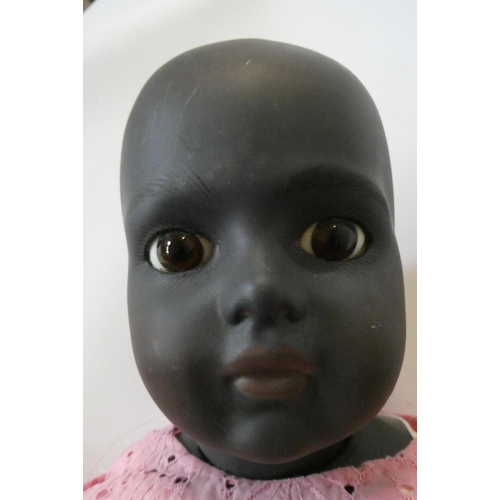 97 - A reproduction Bru bisque socket shoulder head girl doll, with brown glass fixed eyes, closed mouth,... 