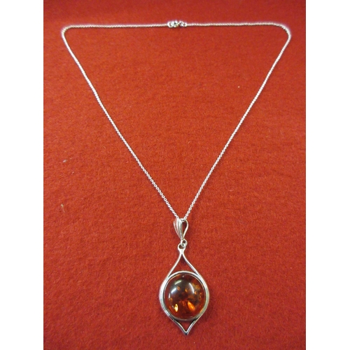 174 - SILVER AND AMBER PENDANT ON A SILVER CHAIN