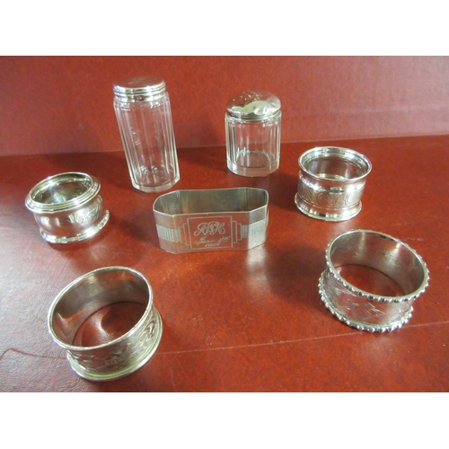 201A - FIVE SILVER NAPKIN RINGS AND TWO SILVER TOPPED BOTTLES