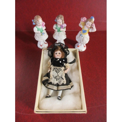 238 - 1928 SMALL DOLL AND THREE FIGURES