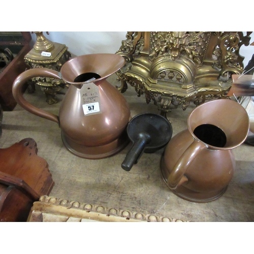 57 - TWO COPPER JUGS AND A CAST IRON PESTLE AND MORTAR