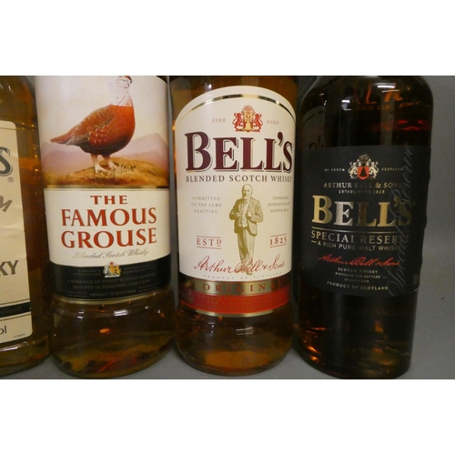 69 - Five bottles of blended scotch whisky, comprising a boxed 70cl Bell's special reserve, a 70cl Bell's... 