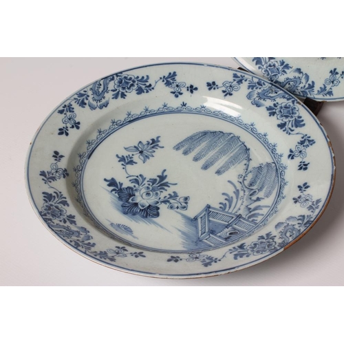 18 - A PAIR OF ENGLISH DELFT CHARGERS, probably Liverpool c.1760, painted in blue with a fence, weeping w... 