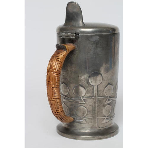 410 - ARCHIBALD KNOX FOR LIBERTY - an English Pewter hot milk jug of cylindrical form, the lower section w... 