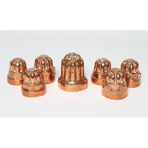 411 - TWO SETS OF THREE SMALL VICTORIAN COPPER JELLY MOULDS of fluted tapering cylindrical form, one set s... 