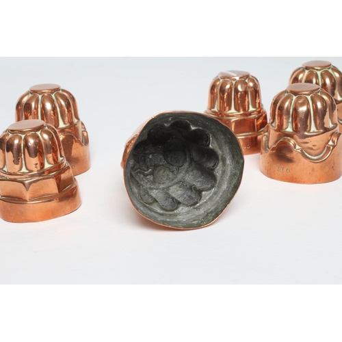 411 - TWO SETS OF THREE SMALL VICTORIAN COPPER JELLY MOULDS of fluted tapering cylindrical form, one set s... 