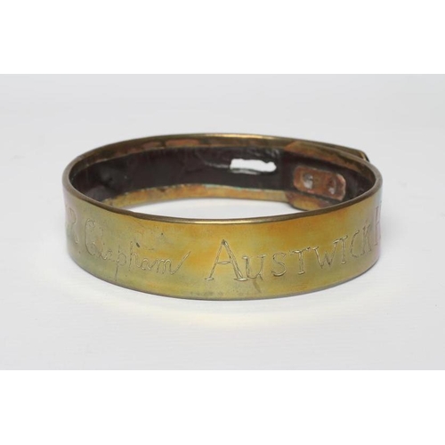 413 - A BRASS DOG COLLAR, early 19th century, engraved 'T R Clapham, Austwick Hall', leather lined, 4 1/2