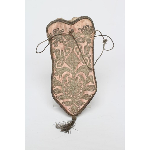 422 - A PINK SILK DRAWSTRING PURSE, possibly early 18th century French, the four shaped panels couched in ... 