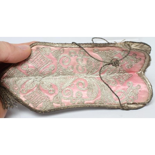 422 - A PINK SILK DRAWSTRING PURSE, possibly early 18th century French, the four shaped panels couched in ... 