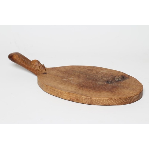 435 - A ROBERT THOMPSON ADZED OAK OVAL CHEESEBOARD with carved mouse trademark, 15