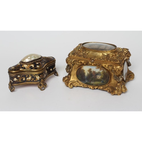 446 - A GILT METAL ROCOCO REVIVAL JEWELLERY CASKET, late 19th century, with inset landscape scenes and red... 