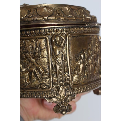 448 - A FRENCH GILDED ORMOLU OVAL MUSICAL JEWELLERY CASKET, early 20th century, with hinged top and mediev... 