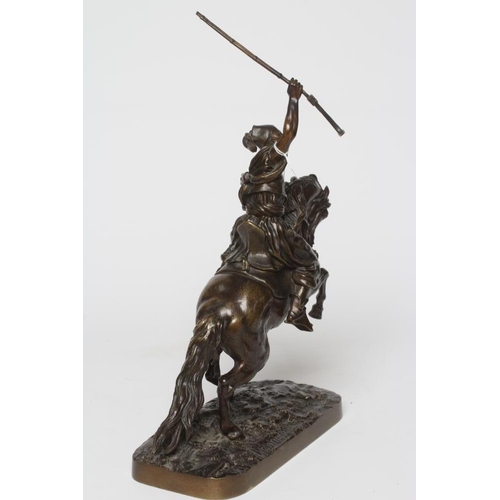 451 - EUGENE LANCERAY (Russian 1848-1886) A horseman with rifle held aloft on a naturalistic base, bronze,... 