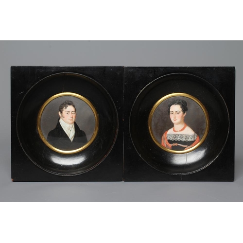 453 - A PAIR OF CIRCULAR IVORY PORTRAIT MINIATURES, 19th century, a gentleman wearing a white stock and bl... 