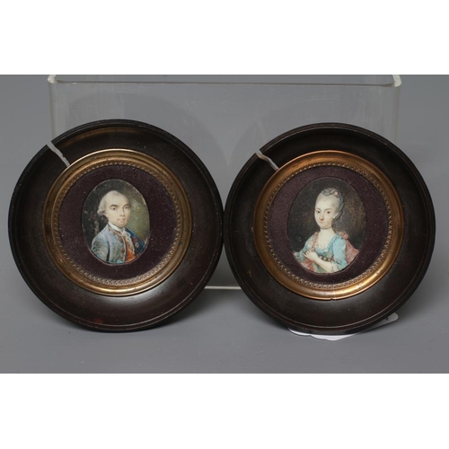 454 - A PAIR OF OVAL IVORY PORTRAIT MINIATURES, 19th century, a gentleman with powdered hair wearing a gre... 