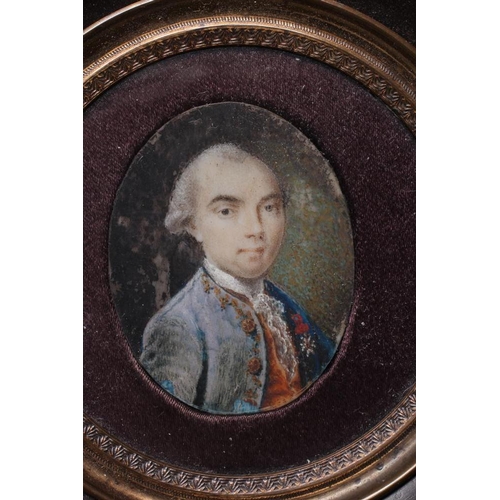 454 - A PAIR OF OVAL IVORY PORTRAIT MINIATURES, 19th century, a gentleman with powdered hair wearing a gre... 