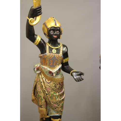 458 - A PAIR OF HAND CARVED POLYCHROME AND GILDED TORCHERE BLACKAMOORS, each full length in costume on pli... 