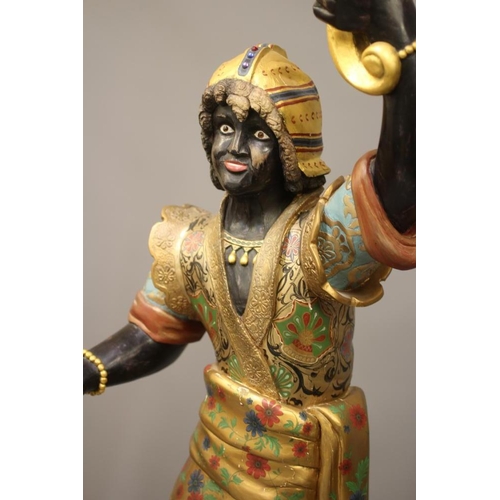 458 - A PAIR OF HAND CARVED POLYCHROME AND GILDED TORCHERE BLACKAMOORS, each full length in costume on pli... 