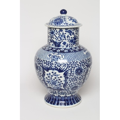 5 - A CHINESE BLUE AND WHITE PORCELAIN LARGE JAR AND COVER of baluster form, painted with panels of flow... 