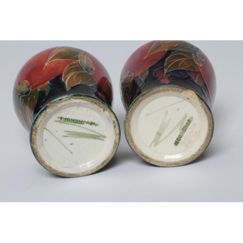 72 - A PAIR OF MOORCROFT POTTERY POMEGRANATE SMALL VASES, c.1915, of inverted baluster form, initialled i... 