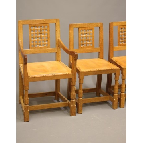 657 - A SET OF SIX ROBERT THOMPSON DINING CHAIRS (4 +2), of open lattice back form with padded cow hide se... 