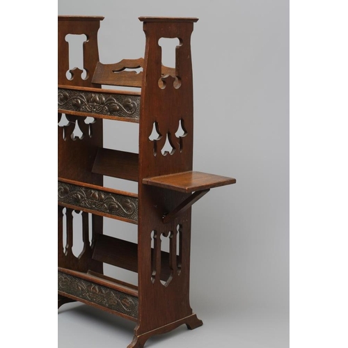 660 - AN ARTS AND CRAFTS OAK BOOKSTAND, c.1900, of oblong three tier form, the pierced and shaped sides wi... 