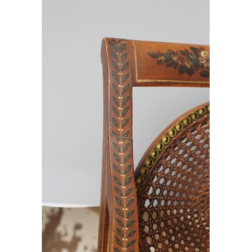 663 - AN EDWARDIAN CANED AND FLORAL PAINTED ELBOW CHAIR, early 20th century, the straight top rail over ov... 