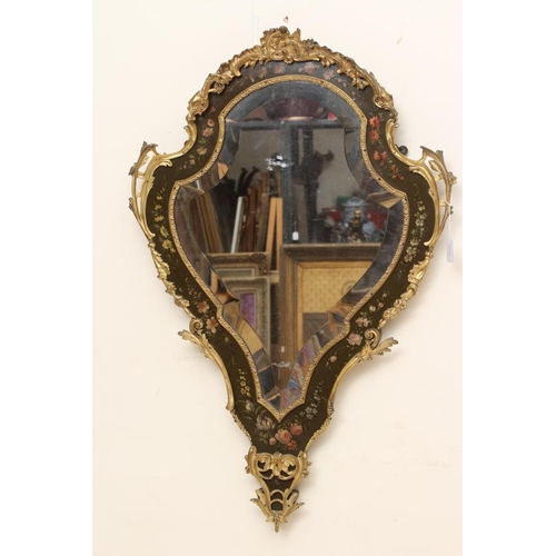 673 - A PAINTED AND GILT METAL MOUNTED WALL MIRROR, 20th century, of shield form in the French rococo styl... 