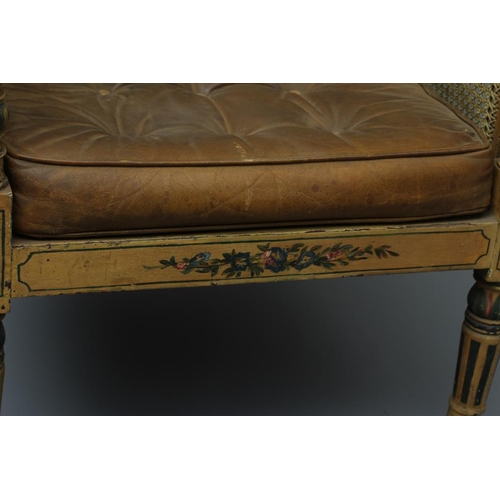 712 - A REGENCY PAINTED MAHOGANY LIBRARY BERGERE, early 19th century, with single caning, the pale brown l... 