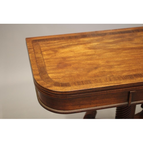 715 - A REGENCY MAHOGANY FOLDING TEA TABLE, early 19th century, of rounded oblong form with rosewood bandi... 