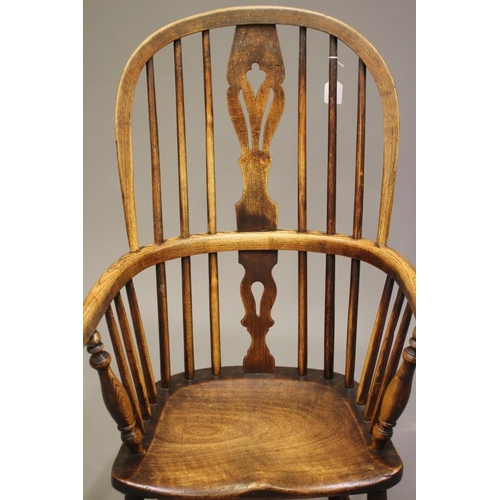 730 - AN ASH AND ELM WINDSOR ARMCHAIR, second half 19th century, the high hoop back with fleur de lys spla... 