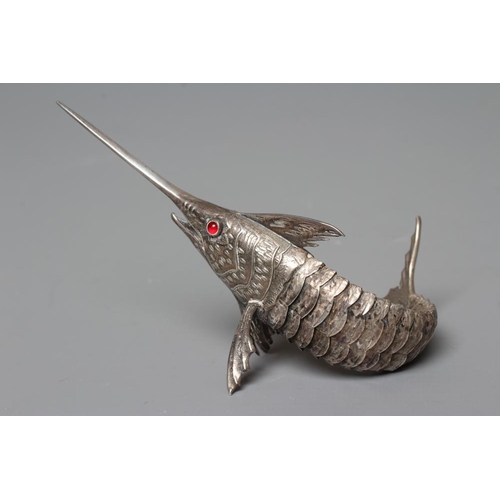 113 - A SPANISH SILVER ARTICULATED SWORDFISH with chased detailing and collet set ruby glass cabochon eyes... 