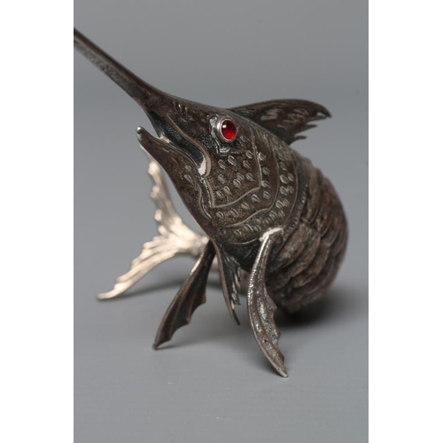 113 - A SPANISH SILVER ARTICULATED SWORDFISH with chased detailing and collet set ruby glass cabochon eyes... 