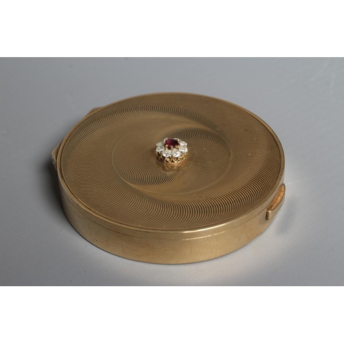 115 - A CARTIER ART DECO 9CT GOLD CIRCULAR COMPACT, London 1945, the concentric circle engine turned cover... 